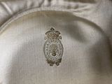 a close up of a white shirt with a gold crest on it