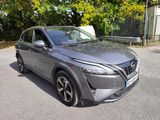 nissan qx - v suv in a parking lot with trees in the background