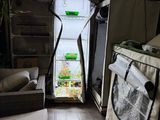 an open refrigerator with a bag on the floor in a room