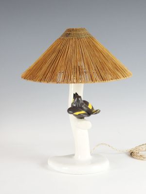 a lamp that has a bird on top of it