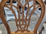 a wooden chair that has a wicker seat on it