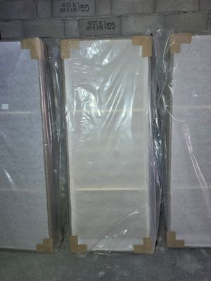 several pieces of white marble are wrapped in plastic and ready to be shipped