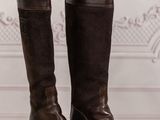 brown leather boots with fur linings on a wooden floor