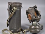 pair of gas masks and a canister on a white background