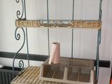 a wicker shelf with baskets on it in a room