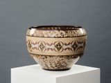 a vase that is sitting on top of a white pedestal