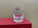 a glass sitting on a red box on a table