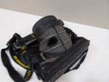 a black bag with a camera on it on a white table