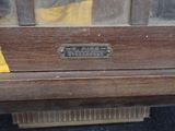 a wooden bench that has a sign on the side of it