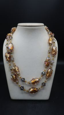 a close up of a necklace on a mannequin display