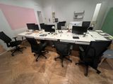 many computers on the desk in this office