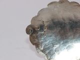 a silver plate with a metal design on it
