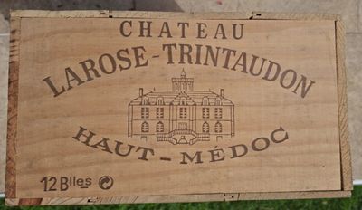 a wooden box with a sign on it that says chateau larose trinidadon