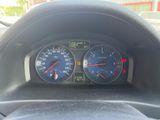 a close up of a car dashboard with a speedometer and gauges