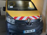 a yellow van with a red and white stripe parked in a garage