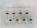 six empty bottles in a plastic container on a table