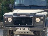 a black land rover parked in front of a house