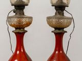 two red vases that are sitting on a table