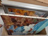 a painting in a box on the floor next to a picture