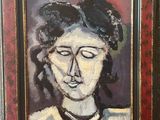 an oil painting of a woman ' s face in a red frame