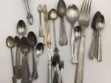 a lot of silver spoons and spoon spoons on the table