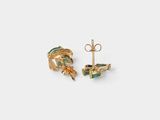 a pair of gold and green earrings on a white background