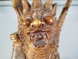 a statue of a dragon that is sitting on top of a table