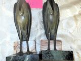 two statues of birds sitting on top of each other