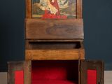 a small wooden box with a painting on it