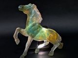 a glass horse that is standing on its hind legs