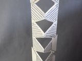 a sculpture of a tall vase with a geometric design