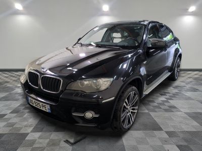 une photo d'un SUV bmw noir garé dans un garage
