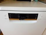 a white dishwasher sitting on top of a kitchen counter
