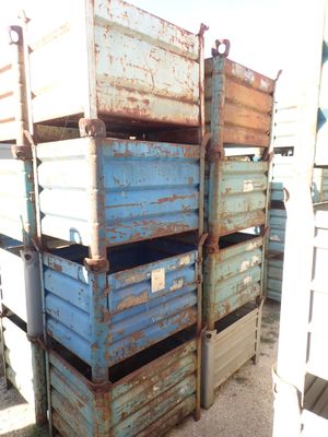 a stack of crates sitting on the side of the road