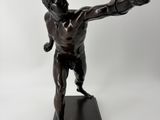 bronze statue of a man holding a baseball bat on a black base