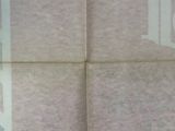 a close up of a tile floor with a stop sign on it
