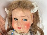 two dolls that are sitting next to each other
