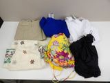 a white table with a bunch of clothing on it