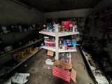 a shelf that has many items on it in a garage
