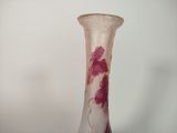 a glass vase that has a pink flower on it