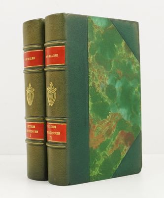 two green books sitting on top of each other on a white surface