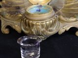 a gold plate with a glass on top of it
