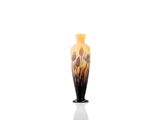 a black and yellow vase sitting on a white surface