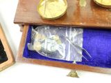 a wooden box with a clock and a pair of scissors in it