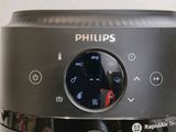 a close up of a black coffee maker on a table