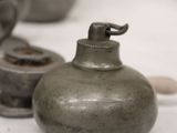 many vases that are lined up on a table