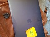 a laptop on a backpack with a sticker on it