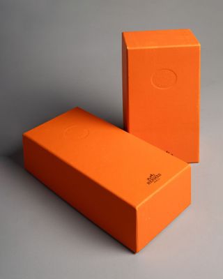 two orange boxes are sitting side by side on a gray surface