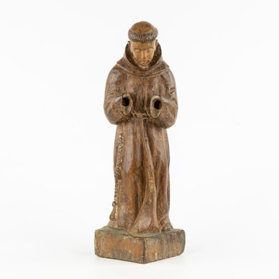 wooden statue of a monk holding a pipe on a white background
