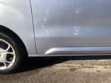 a small silver car parked on the side of the road